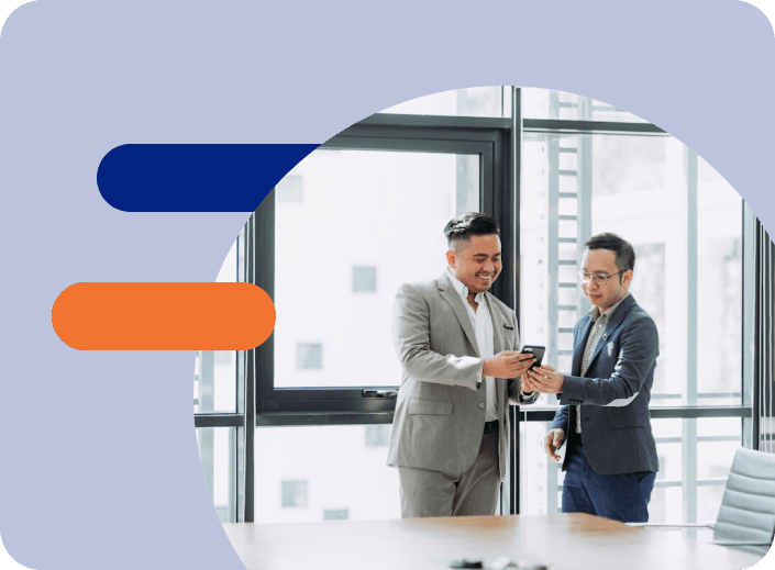 Business partners looking at phone